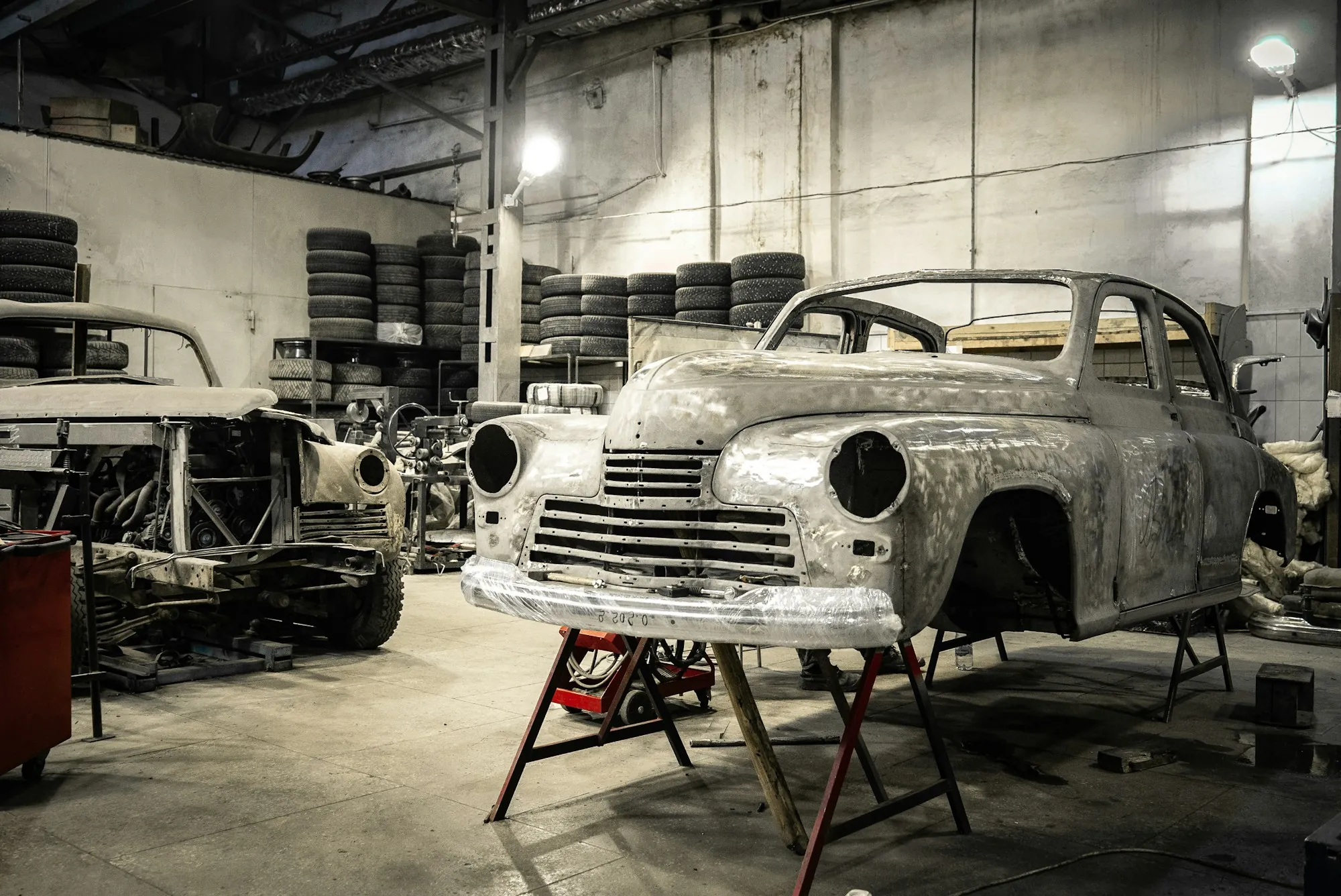 Technician working on the body of a car in a garage
